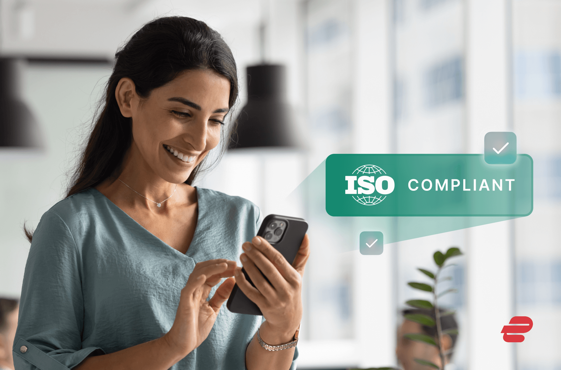 Woman confidently using mobile phone with ISO logo superimposed
